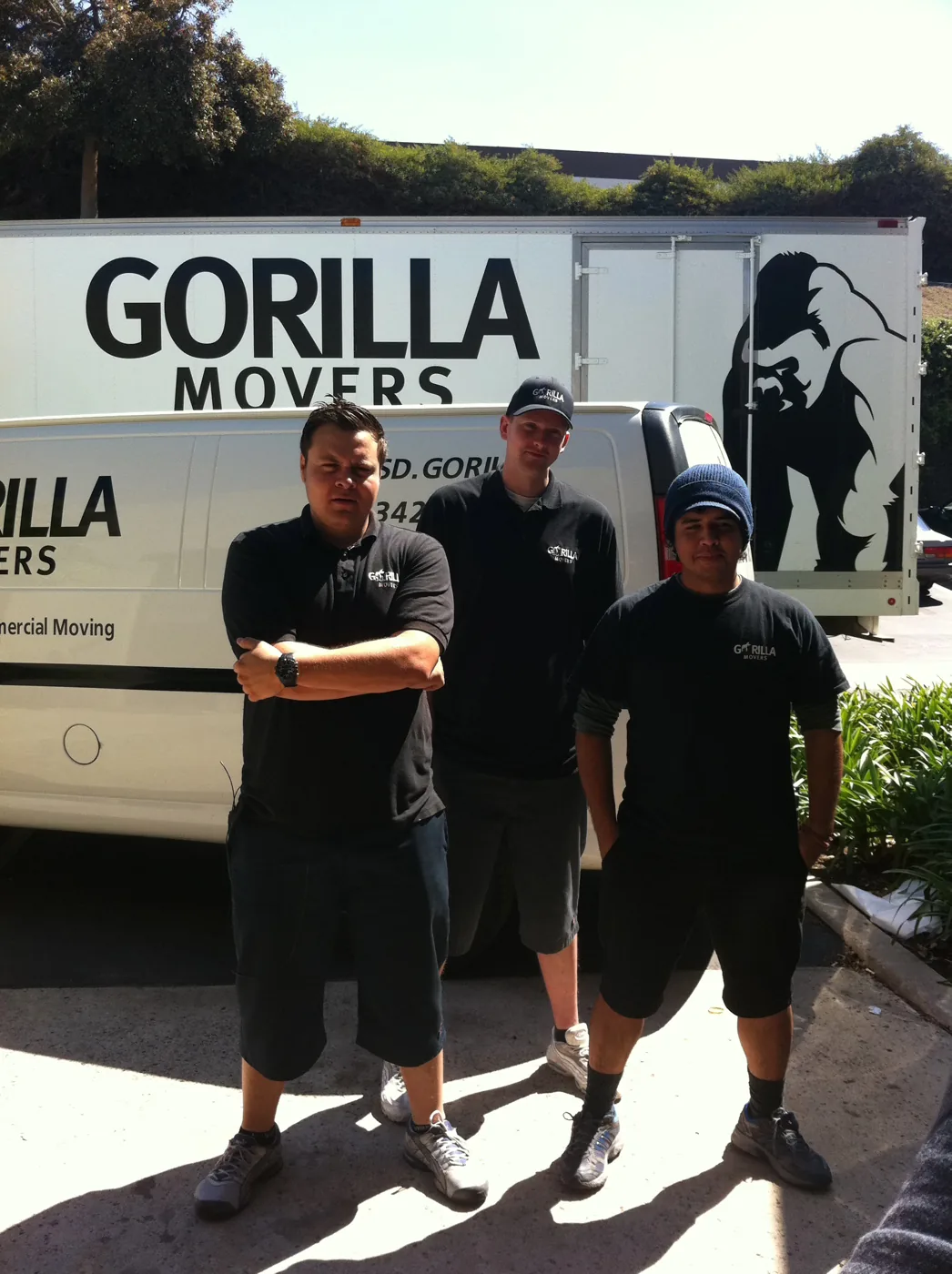 Three Gorilla Movers crew members standing by the truck