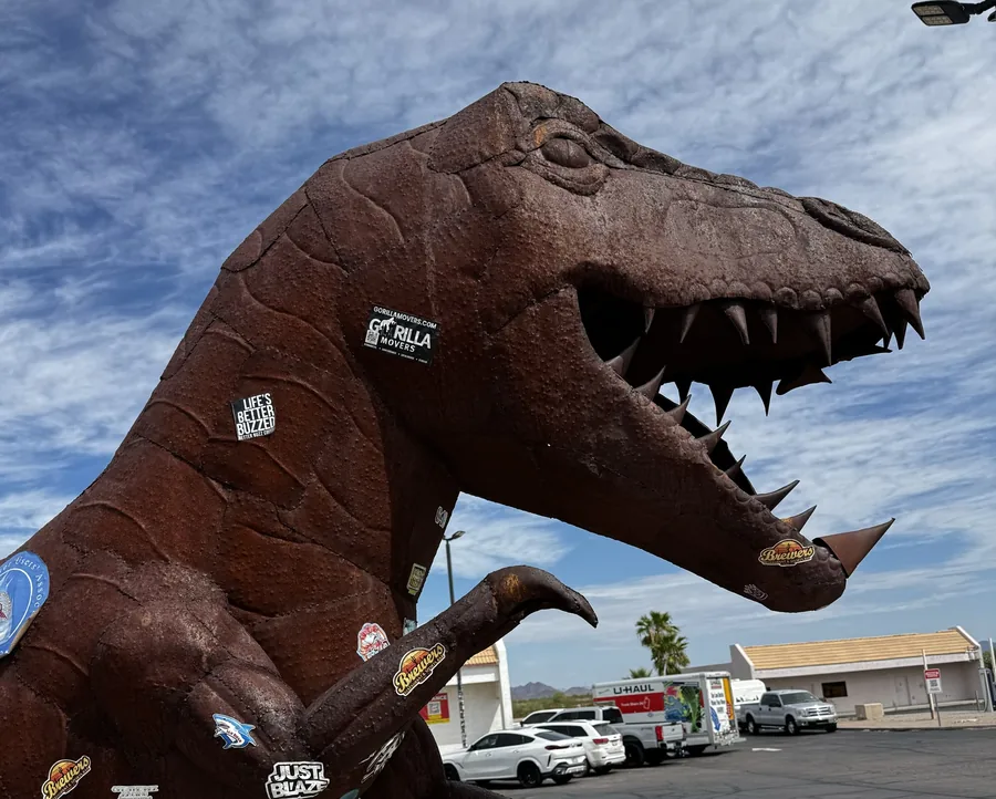 A Gorilla Movers sticker on the big metal dinosaur sculpture at Gila Bend, Arizona, a landmark stop on the I-8 route to Phoenix
