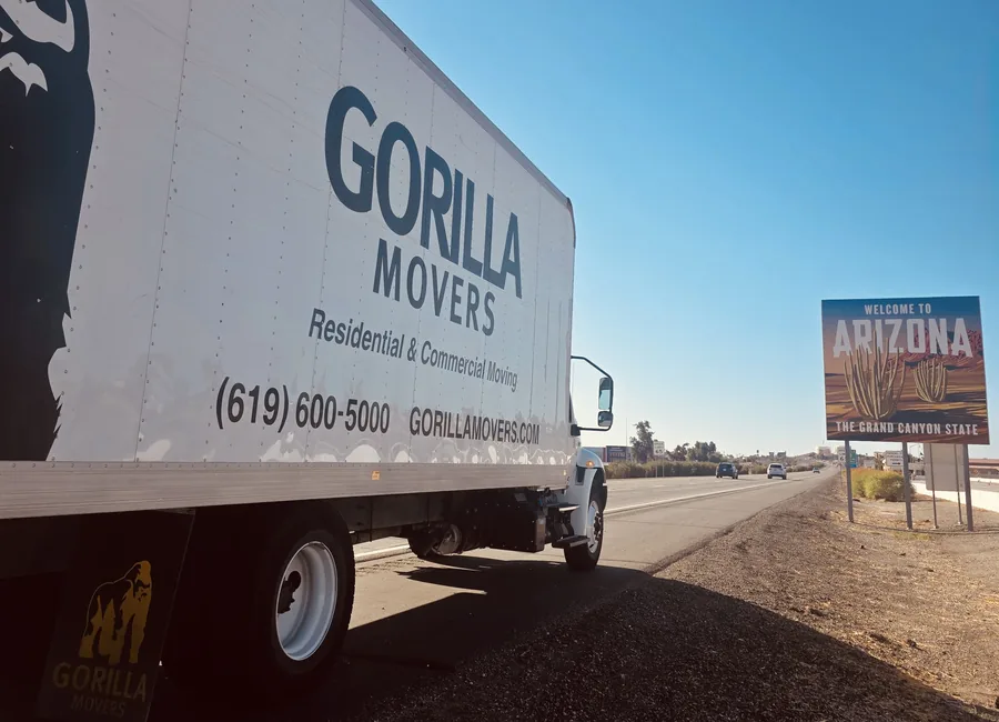 A Gorilla Movers box truck pulled over at the Welcome to Arizona state line sign on Interstate 8