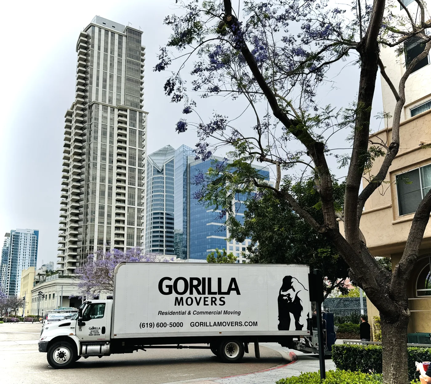 Gorilla Movers truck on a downtown San Diego street below the high-rises
