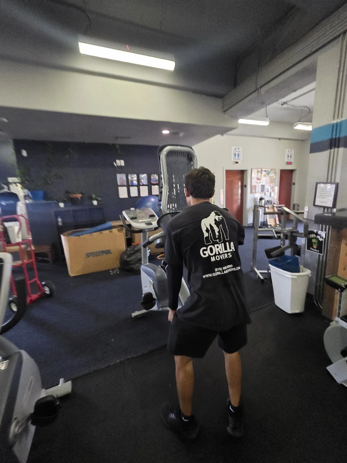 Gorilla Movers reassembling weight bench at La Jolla fitness center