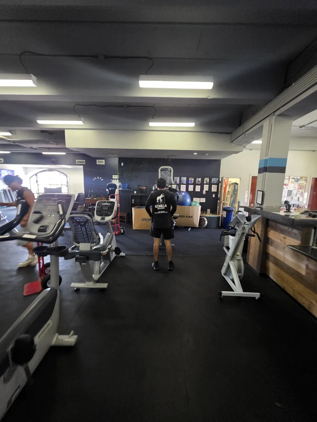 Gorilla Movers positioning plate-loaded machine in La Jolla gym