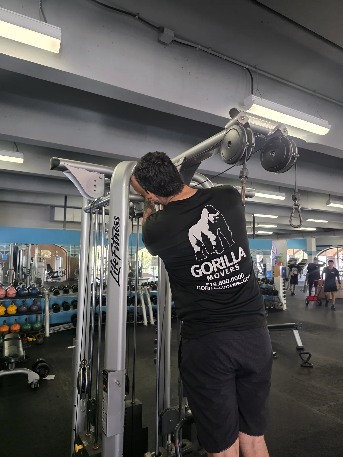 Gorilla Movers installing cable crossover system in La Jolla gym