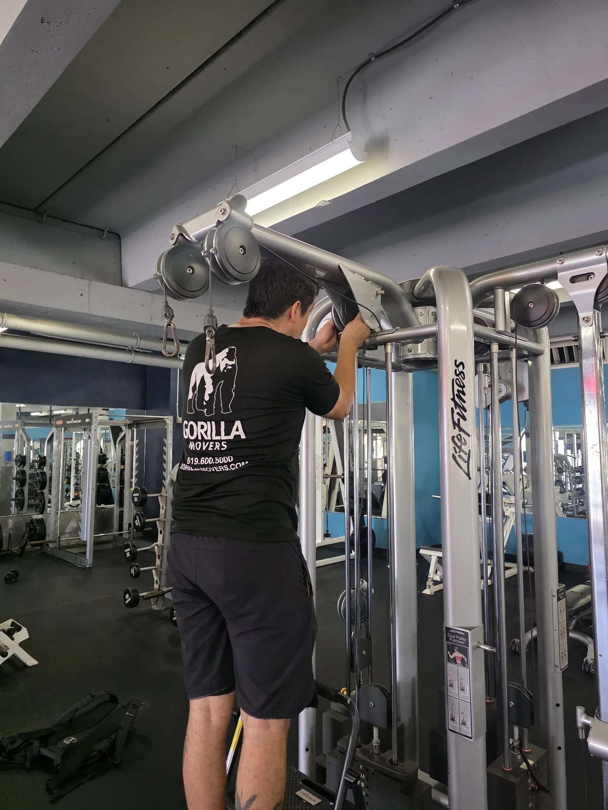 Gorilla Movers arranging dumbbell rack at La Jolla fitness studio