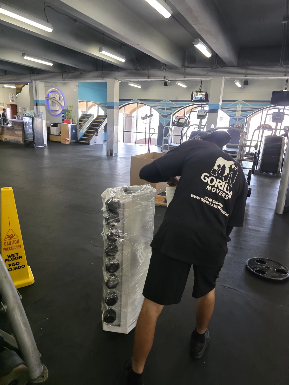 Gorilla Movers calibrating resistance machine in La Jolla gym