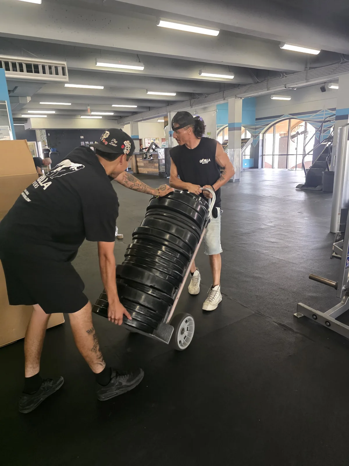 Gorilla Movers crew organizing locker room equipment in La Jolla gym