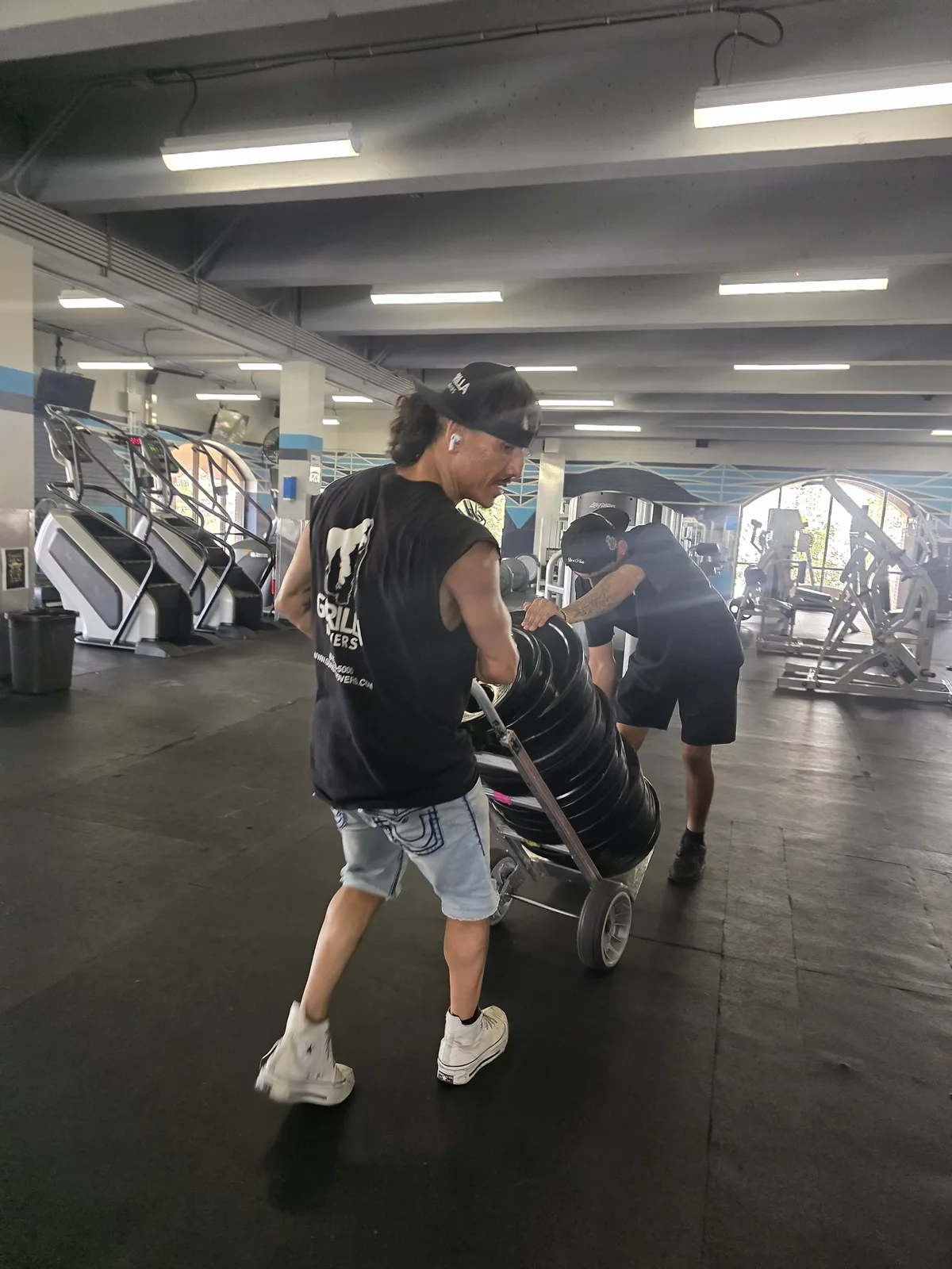Gorilla Movers installing safety mats around gym equipment in La Jolla