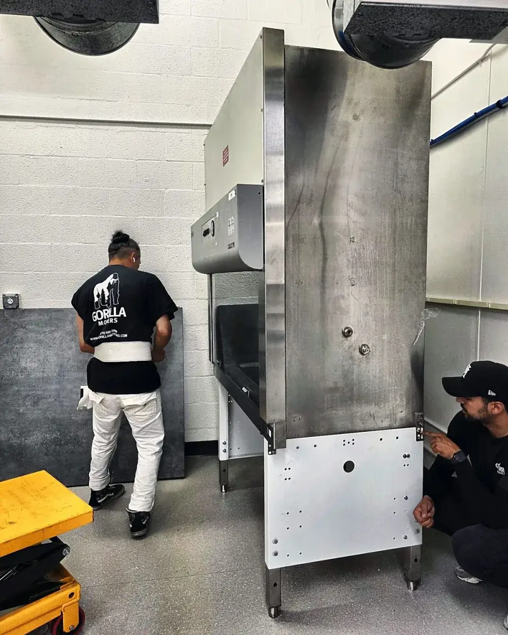 Stainless steel fume hood on a lift table during a San Diego laboratory relocation