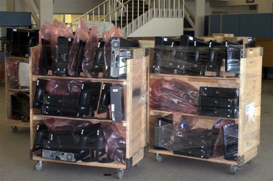 Office computers and monitors anti-static wrapped and staged on carts for a San Diego commercial move
