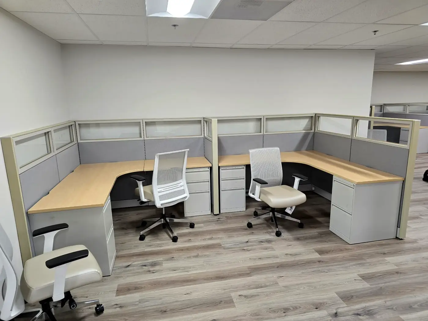 Finished pair of modular cubicle workstations with task chairs in a San Diego office