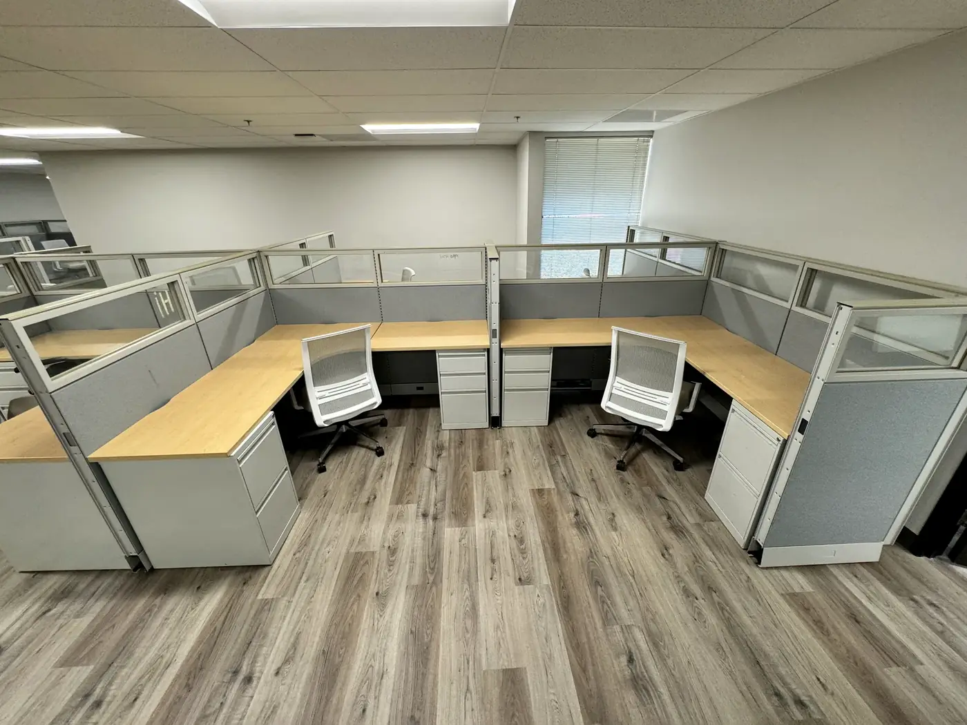 Pair of installed cubicle workstations with task chairs during an FF&E project in San Diego