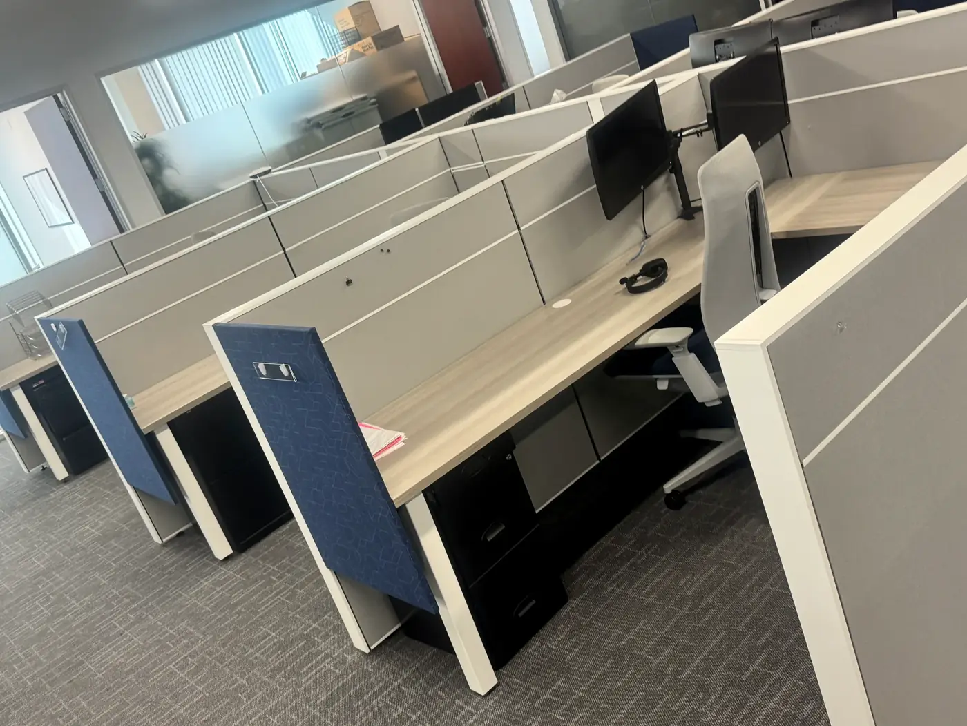 Modern benching workstations with dual monitors reinstalled after a San Diego office move