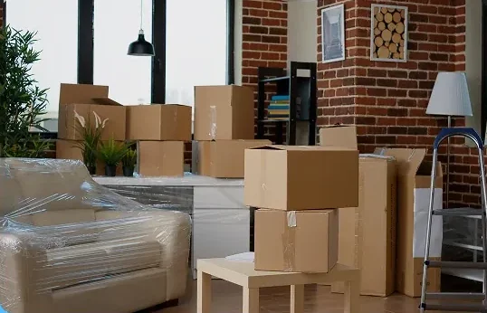 Packed and shrink-wrapped office furniture and boxes staged for a San Diego office move