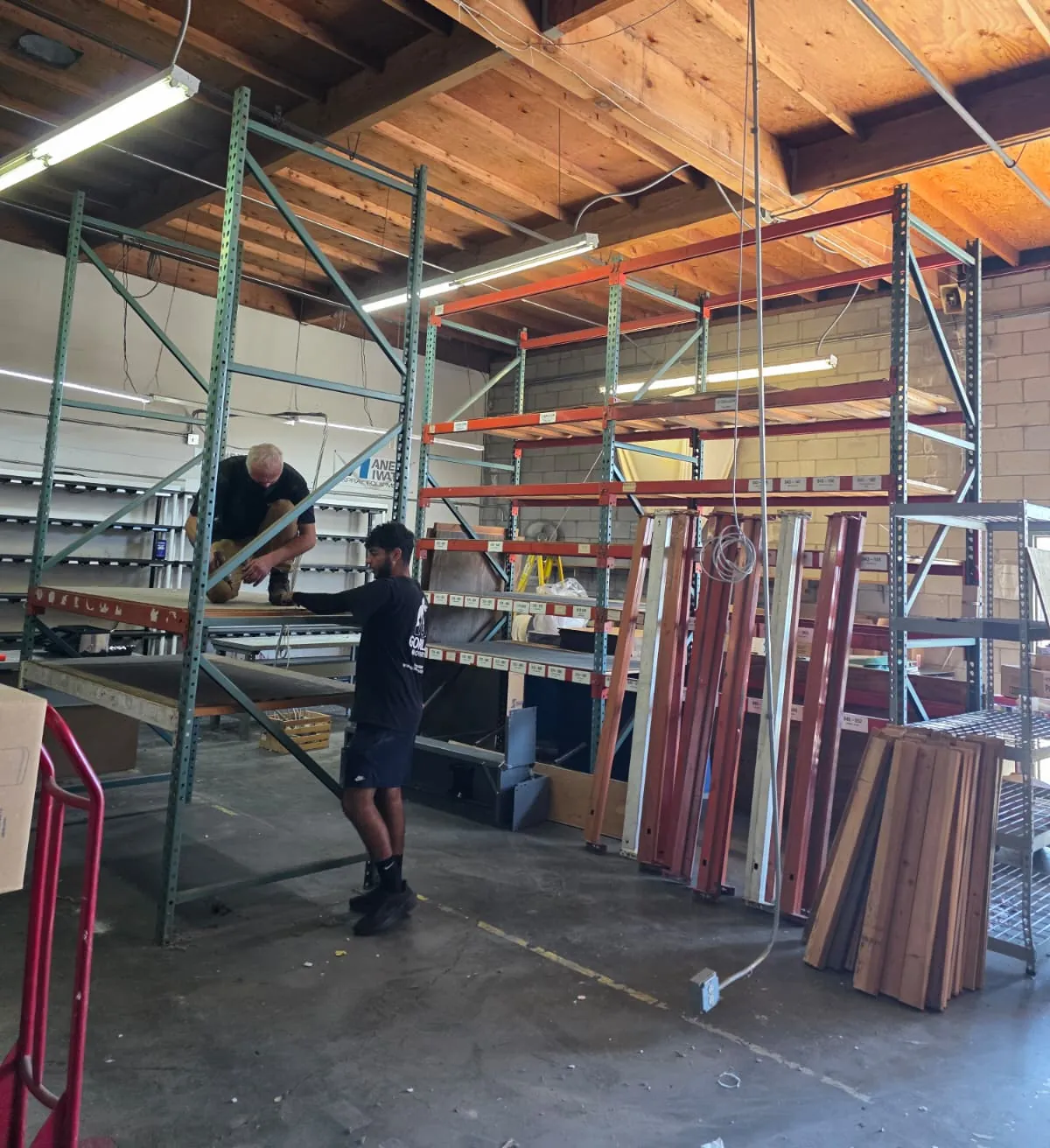 Gorilla Movers crew tearing down pallet rack shelving during a San Diego warehouse move