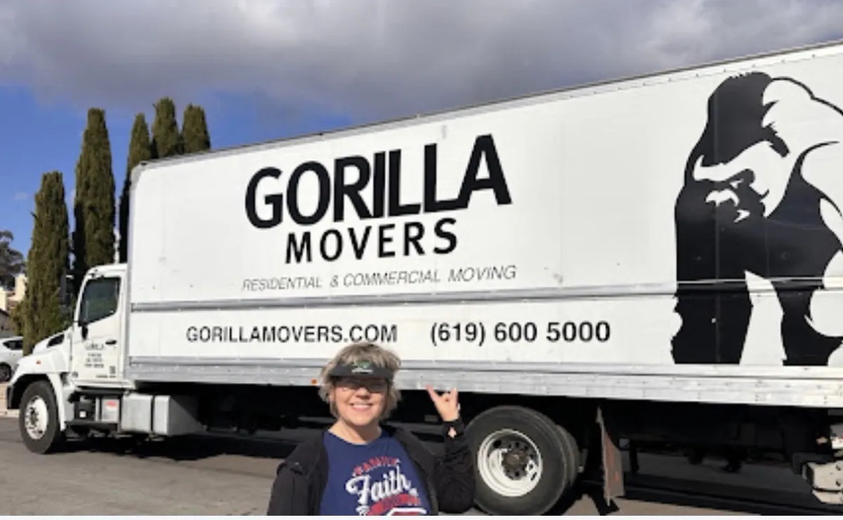 Tracee Denby standing with a Gorilla Movers truck in San Diego