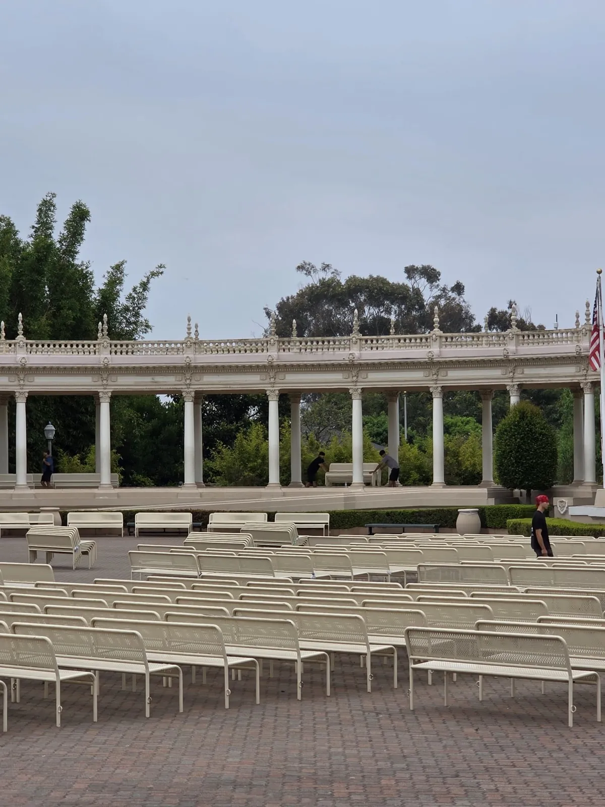 A Gorilla Movers mover carrying a bench at the Spreckels Organ Pavilion