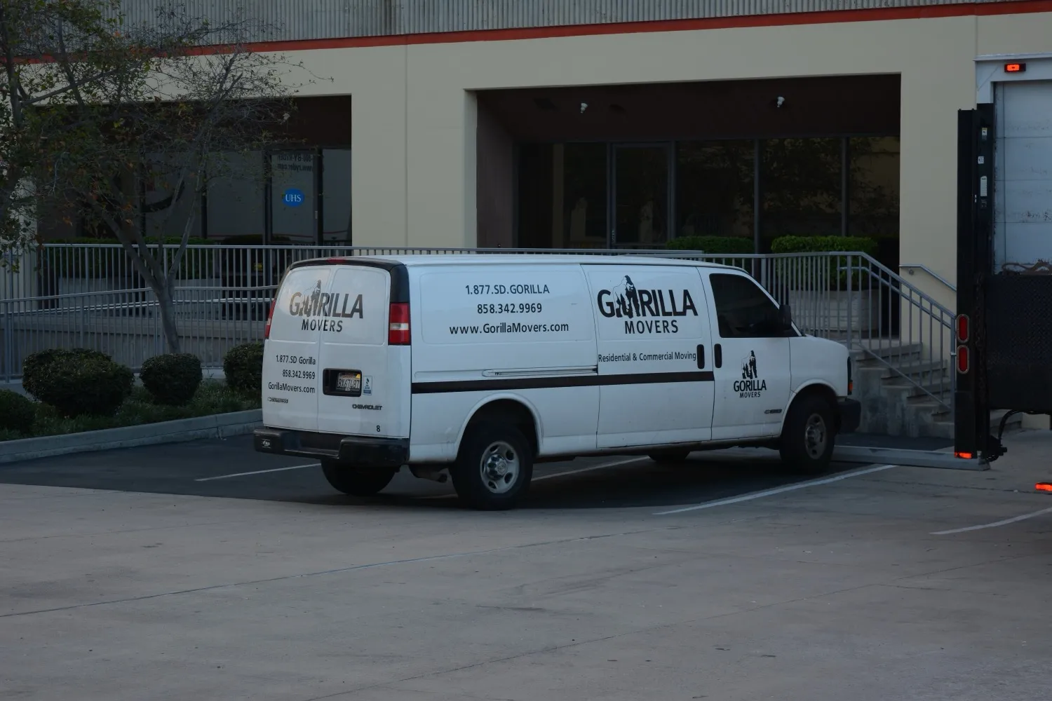 A Gorilla Movers van at a commercial building for a San Diego gym equipment move