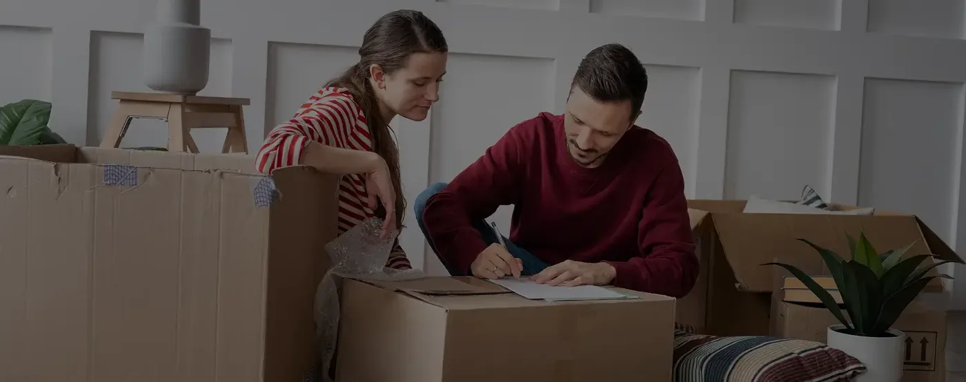 Couple packing a small box shipment for a mini move