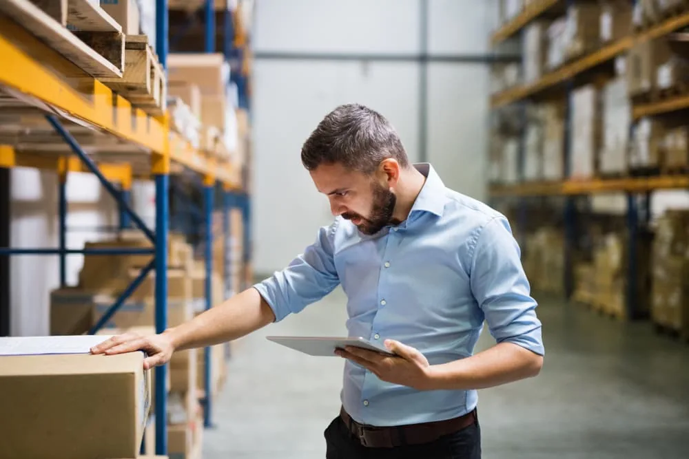 Technician inspecting warehouse pallet racking